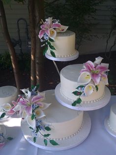 three tiered wedding cakes with flowers on them