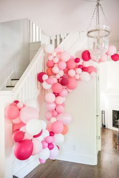 the staircase is decorated with pink and white balloons