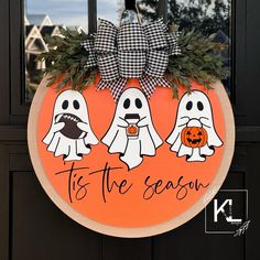 a door hanger with three ghostes and the words tis the season on it