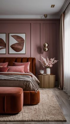 a bedroom with pink walls and brown furniture