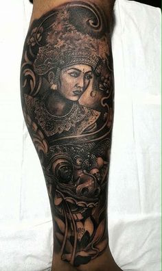 a man's leg with tattoos on it and an image of a woman in the middle