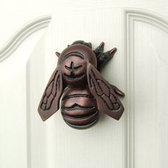 a close up of a door handle with a bee on it's face and eyes