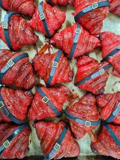 strawberries wrapped in blue ribbon and tied to the side, with buckles on them