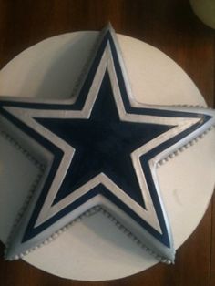 a cake decorated with a star on top of a table