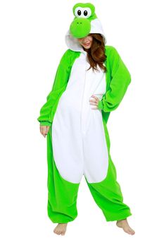 a woman in a green and white frog onesuit is standing with her hands on her hips