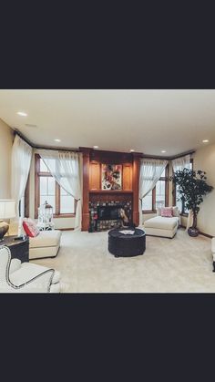 a living room filled with furniture and a fire place in the middle of a room