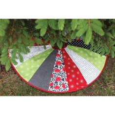 a christmas tree skirt sitting under a pine tree