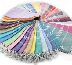 the colors of towels are arranged in a circle on top of each other with fringes