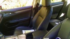 the interior of a car with black leather seats