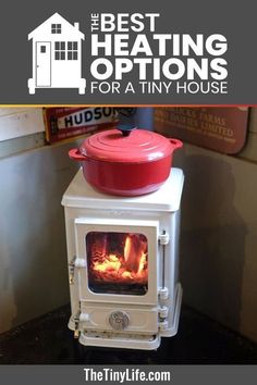 an old fashioned stove with a red pot on top