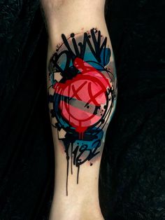 a person with a tattoo on their leg that is covered in grafitti and has a red heart