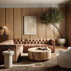 a living room filled with furniture and a tree in the corner on the wall behind it