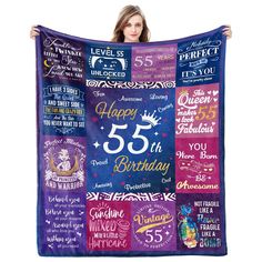 a woman is holding up a birthday blanket