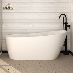 a white bath tub sitting next to a black faucet