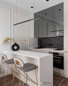 a kitchen with white counter tops and gold bar stools