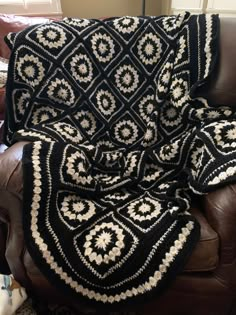 a black and white afghan sitting on top of a couch