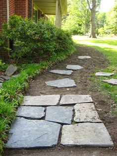 a stone path in front of a brick building