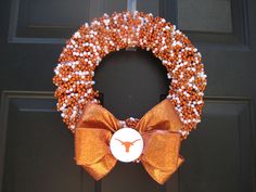 an orange and white beaded wreath on a door