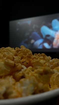 a plate full of food with a television in the background