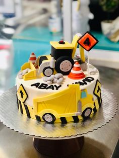 a birthday cake with construction vehicles on it