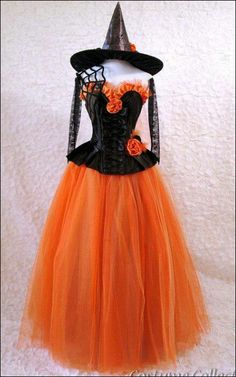 an orange and black dress with a witch hat on top