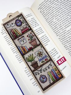 an open book with cross stitch designs on it