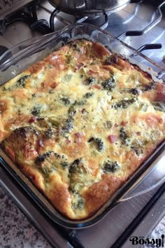 a square casserole dish with broccoli and cheese on the top in a glass pan