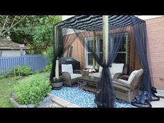 an outdoor living area with furniture and mosquito netting