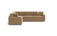 a large sectional couch sitting on top of a white floor next to a footstool