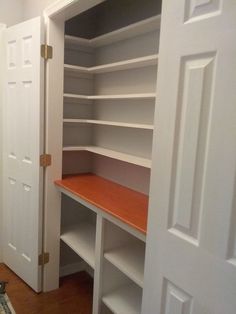 an empty walk in closet with shelves and doors