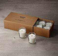 six candles in a box on the ground