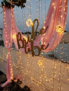 a sign that says bridal hanging from the side of a building with lights on it