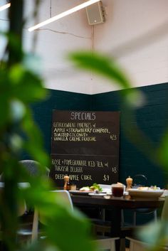 a restaurant with tables and chairs in front of a sign that says specials on the wall