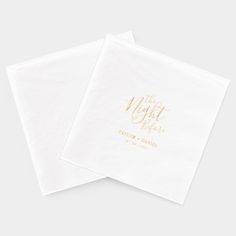 two white napkins with gold foil lettering on the front and back of each one