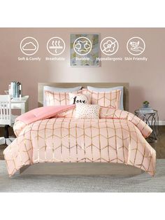 a bed with pink comforter and pillows on it