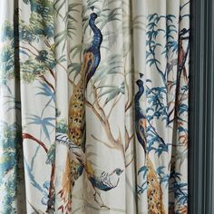 the curtains are decorated with peacocks on them