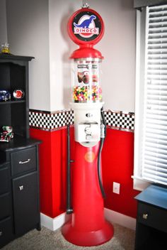 a candy dispenser in the corner of a room