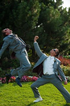 two men are jumping in the air to catch a frisbee