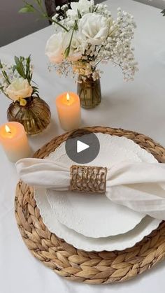 the table is set with white flowers and candles