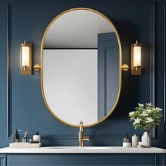 a bathroom sink with a large mirror and lights on the wall above it, next to a vase with flowers