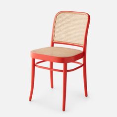 an orange chair with wicker back and seat