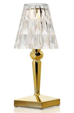 a gold table lamp with a white shade