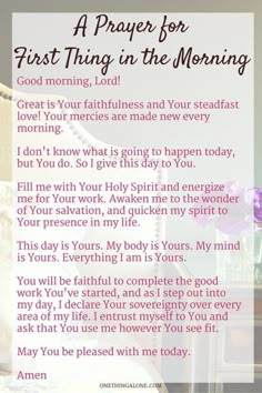 a prayer for first thing in the morning with pink flowers on a table next to it