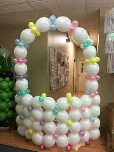 balloons are arranged in the shape of a heart on a table next to a mirror