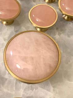 some pink and gold knobs on a table