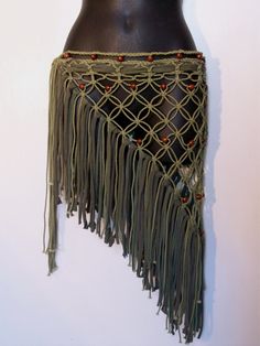 a woman's torso wearing a crochet and beaded skirt