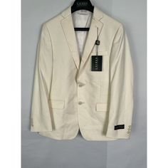 This Lauren Ralph Lauren Boy's Suit Blazer In Size 14r Is A Perfect Addition To Your Kid's Wardrobe. The Blazer Has A Solid Pattern With A White Color That Makes It Suitable For Casual Occasions. It Has Long Sleeves And A Regular Jacket/Coat Length. The Blazer Is Made Of A Blended Fabric Of Polyester And Rayon And Is Dry Clean Only. The Blazer Has A Single-Breasted Cut With A Two-Button Jacket Front Button Style. It Has A Tuxedo Style With Lined And Inner Pockets. The Blazer Comes In A Set That Slim Fit Blazer For Spring, Slim Fit Spring Blazer With Flat Front, Beige Long Sleeve Suits For Spring, Formal Cream Cotton Blazer, Tailored White Suits For Winter, Tailored White Winter Suits, Classic Slim Fit Spring Blazer, Cream Business Blazer For Spring, Slim Fit Spring Suit With Flat Front