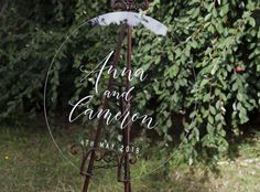 a sign that says ann and cannon on it in front of some trees with leaves