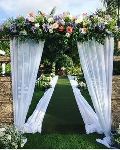 an outdoor ceremony with white drapes and flowers