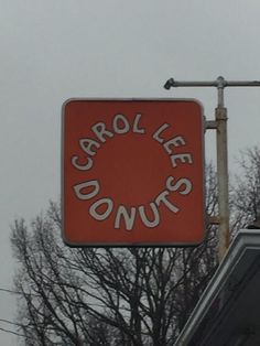 an orange sign that says carol lee donuts on it